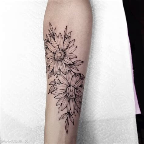 A Black And White Photo Of A Sunflower Tattoo On The Right Arm With