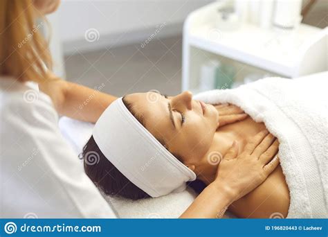 Woman Patient Getting Manual Relaxing Rejuvenating Massage For Face And Shoulders From Therapist