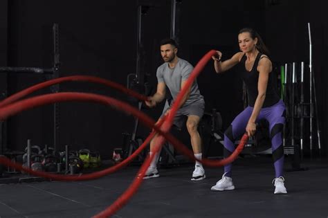 Premium Photo Athletic Young Couple With Battle Rope Doing Exercise