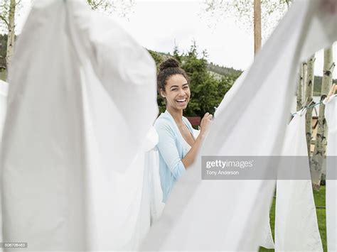 Young Woman Hanging The Laundry Outdoors Photo Getty Images