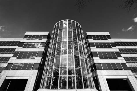 Low Angle Grayscale Of An Elegant Modern Building With Smooth Glass