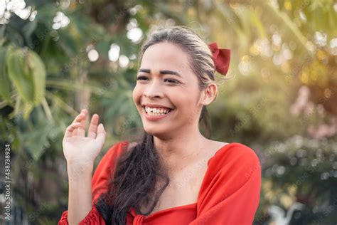 Portrait Of A Happy And Upbeat Asian Transgender Woman In A Red Dress Outdoors Afternoon Scene