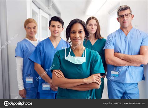 Portrait Multi Cultural Medical Team Standing Hospital Corridor Stock