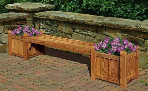 Two Wooden Planters With Purple Flowers In Them Sitting On A Brick