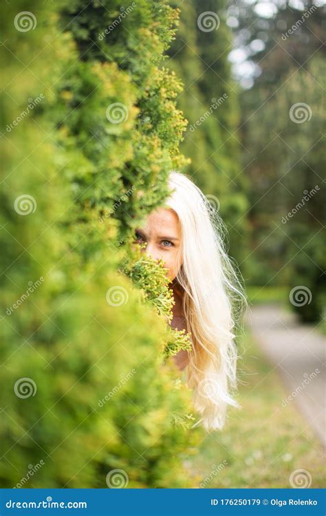 Blonde Woman With Long Hair On A Summer Day Hiding Behind The Bush Stock Image Image Of Cute