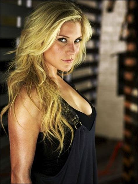 a woman with long blonde hair posing for the camera