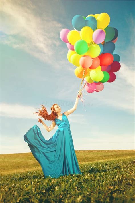 Luxury Fashion Woman With Balloons In Hand On The Field Against Stock