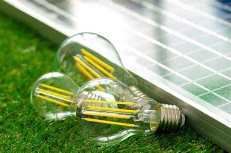 Solar Energy Panel And Light Bulb Green Energy Concept Stock Photo