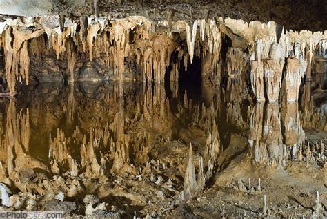 Stalactites Reflect In Underground Water Pool In Luray Caverns
