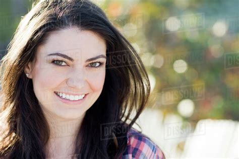 Hispanic Woman Smiling Outdoors Stock Photo Dissolve