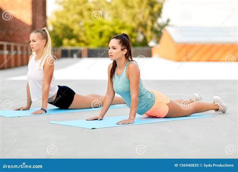 Women Doing Sports On Exercise Mats Outdoors Stock Photo Image Of Person Posture