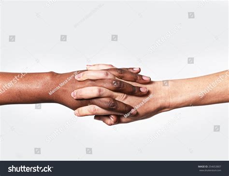 White Caucasian Female Hands And Black African American Holding Fingers