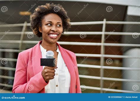 Young African American Woman Journalist Holding Reporter Microphone