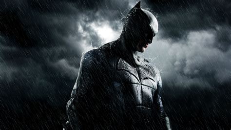 The Dark Knight Rises Movie Poster With Batman Standing In The Rain And