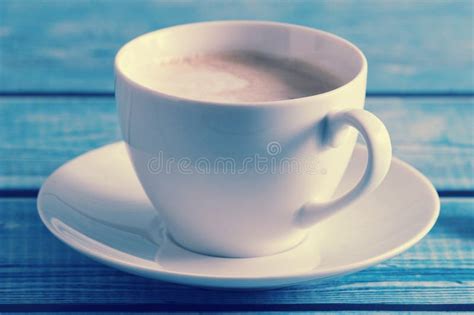 Frothy Coffee Cappuccino In A White Mug On A Blue Background Stock