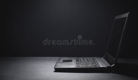 Black Laptop On The Black Office Desk Technology Concept Stock Photo