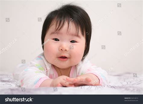 Beautiful Baby Asian Girl Infant Smiling While Crawling Stock Photo