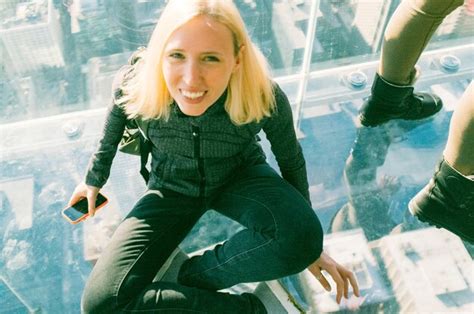 Premium Photo Portrait Of Woman Sitting On Glass At Skydeck Chicago