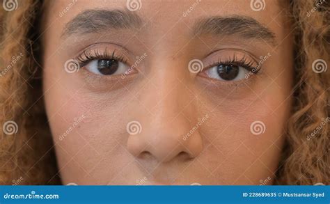 Close Up Of Blinking Eyes Of Beautiful African Woman Stock Image