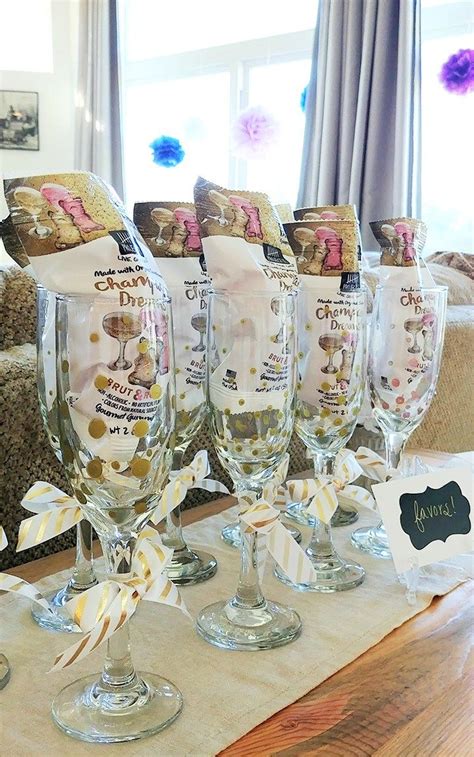 Five Wine Glasses Sitting On Top Of A Table Next To Bags Of Cookies And