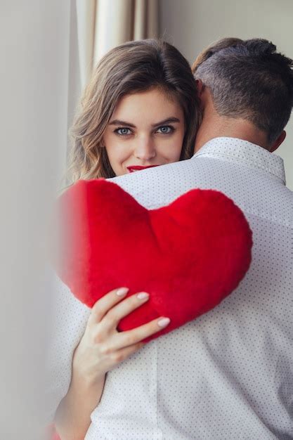 Free Photo Portrait Of A Pretty Young Woman Holding Her Boyfriend