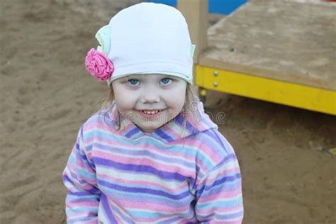 Little Pretty Girl In Hat Smiles On Children Playground Stock Image