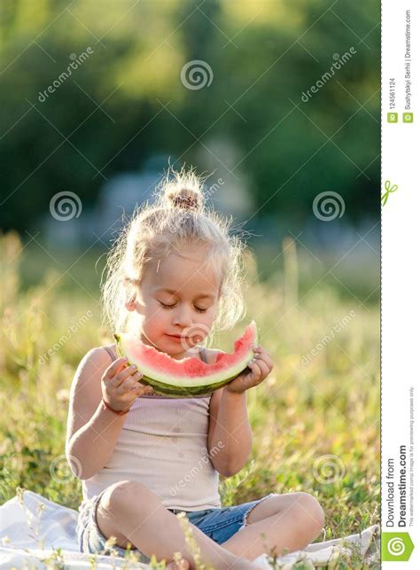 Little Blond Girl Eating Watermelon In The Park Stock Photo Image Of