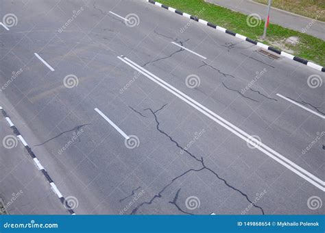 Damaged Bad Asphalt Road With Potholes Patch Repair Of Asphalt Stock