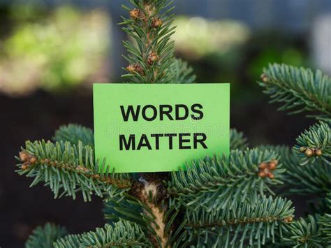 A Green Sticky Note With The Phrase Words Matter On It Being Held Up By