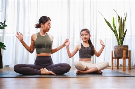 Asian Young Mother And Her Daughter Setting Prepare To Yoga And Meditation Pose Together On Yoga