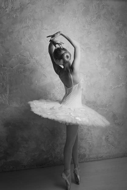 Premium Photo A Young Ballet Dancer In A White Tutu Performing Pointe