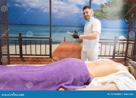 Young Woman Laying Down At The Massage Table And Doing Hijama Treatment Thumb Up By Therapist