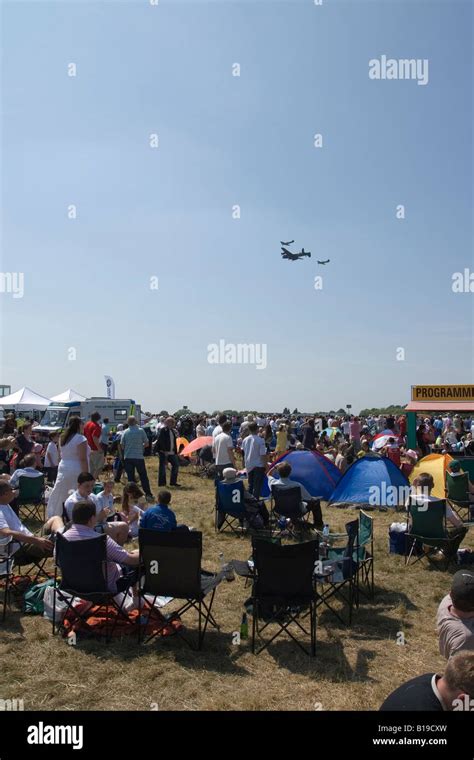 Spectators Watch Wwii Lancaster Bomber Flanked By Hurricane And