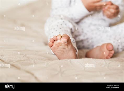 A Close Up Of Tiny Baby Feet Newborn Baby Legs On The Bed Stock Photo