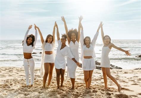 Premium Photo Joyful Multiracial Women With Hands Up Posing On The Beach Having Fun And