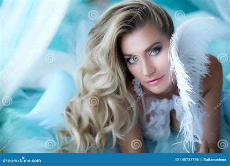 Boudoir Photography Woman Blonde With Long Hair In Lingerie On The Bed Surrounded By Flowers