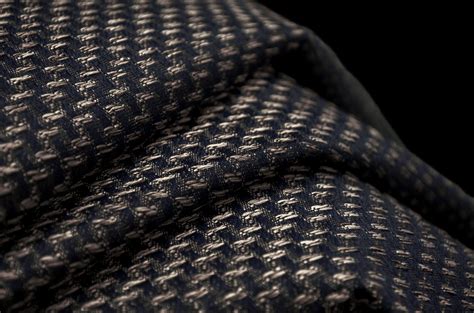Closeup Of The Texture Of A Dark Blue And White Tweed Fabric With Small