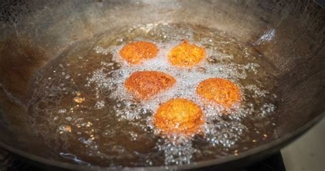 deep frying falafel balls in wok hot cooking oils bubbling and falafel balls turned golden