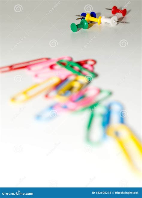 Push Pins And Paper Clips In Different Colors Isolated On White
