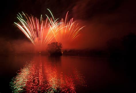 Landscape Photo Of Fireworks In The Sky Near Water Formation During