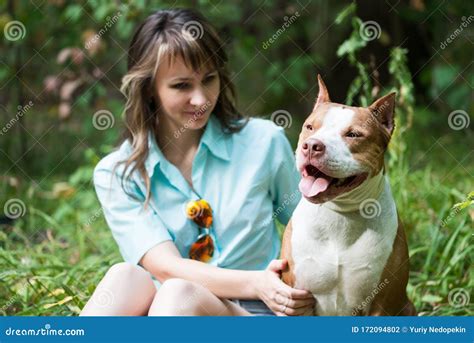 Beautiful Woman Sitting On Grass With Dog Pit Bull Stock Photo Image