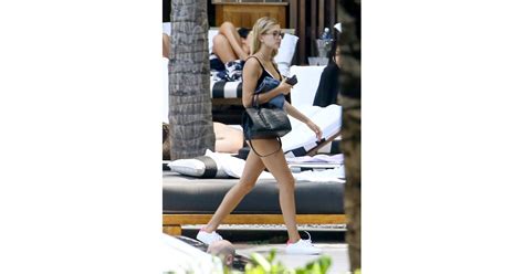 get hailey s poolside style hailey baldwin sneakers by the pool june 2016 popsugar fashion