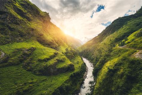 Amazing Mountains Covered Green Grass River At Sunset Stock Image