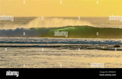 Cinemagraph Of Surfer On Ocean Wave At Sunset Stock Video Footage Alamy