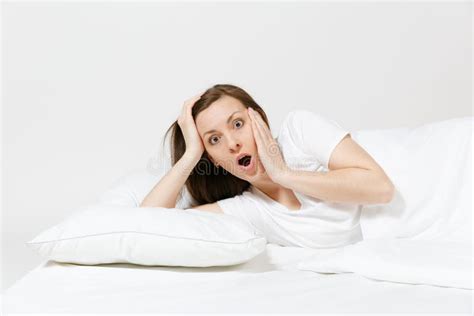 Calm Young Brunette Woman Lying In Bed With White Sheet Pillow