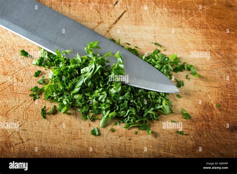 Chopped Parsley With Knife On Cutting Board Stock Photo Alamy