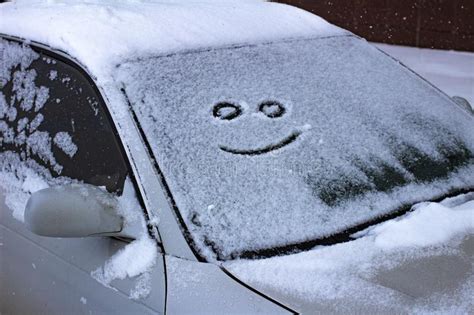 Happy And Sad Smiley Emoticon Face In Snow On Car Windows