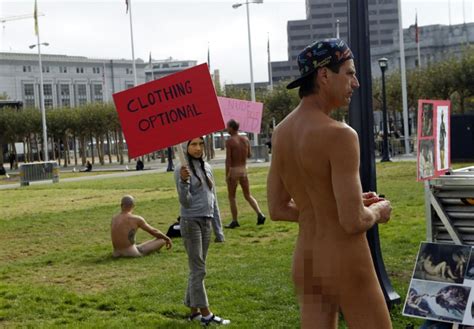 Inti Gonzalez 11 Carries A Sign Near Nude Men
