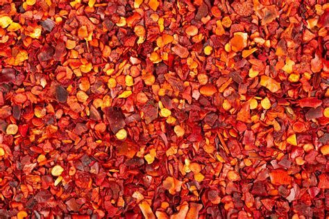Premium Photo Dried Red Chili Flakes With Seeds Background Chopped