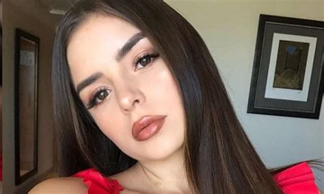 Demi Rose Flaunts Her Ample Bust In A Deeply Plunging Red Top Before